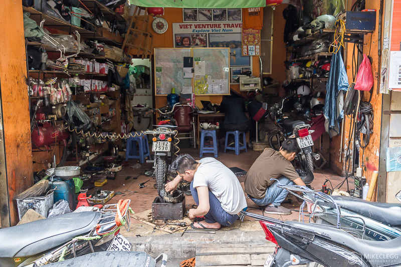 Men working in motorbike shops in Hanoi