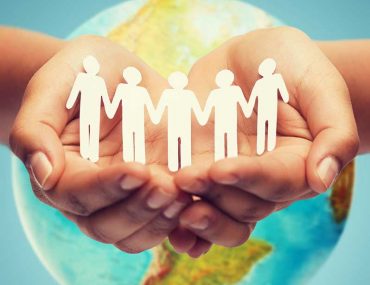 People holding hands and helping each other around the world - concept