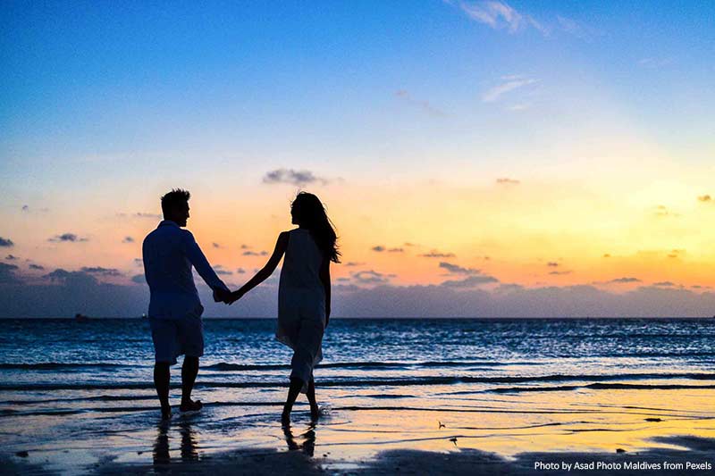 5 Tropical Havens You Have to Visit as a Couple Couple holding hands on a beach