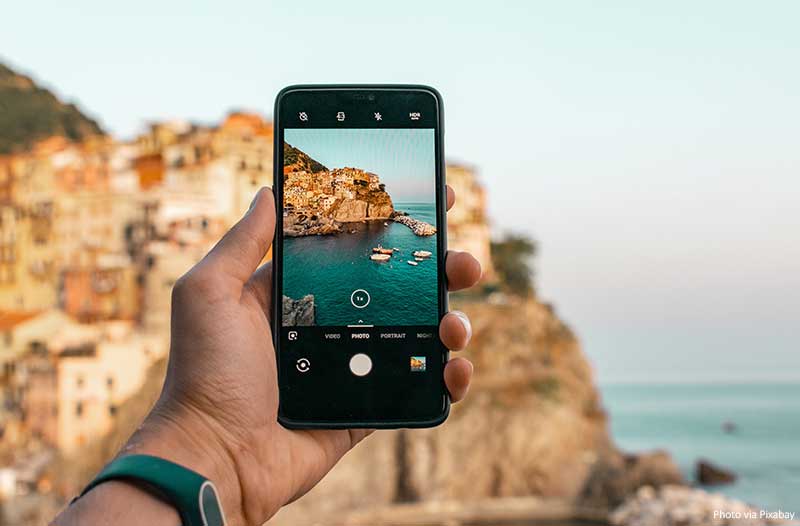 How to Take Great Instagram Pictures Taking pictures at a travel destination on a smartphone