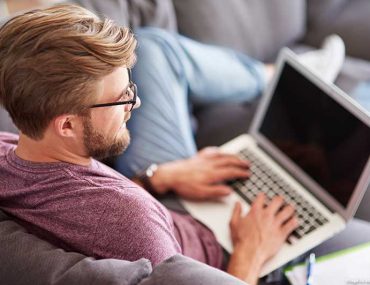 Man at home with laptop