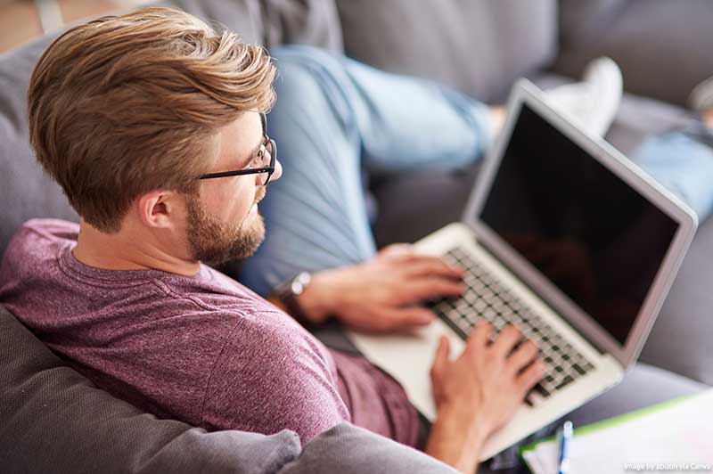 How to Keep Busy During a Pandemic and You Can’t Travel (Ideas for Those Self-Isolating) Man at home with laptop