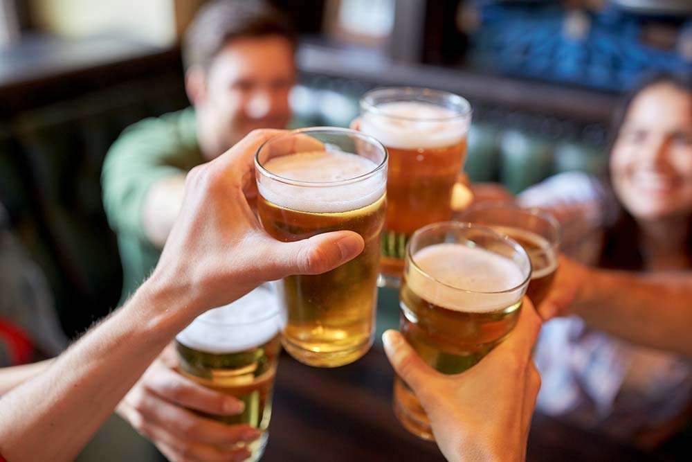 Group of people clinking beer glasses